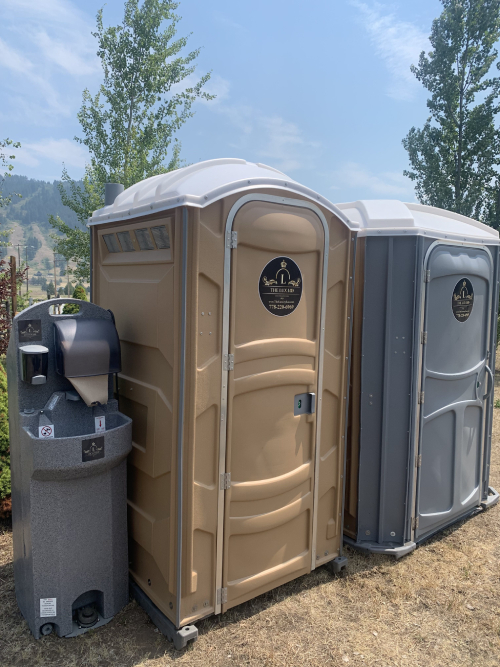 luxury porta potty unit placed in a shaded backyard in Kamloops BC during a summer party