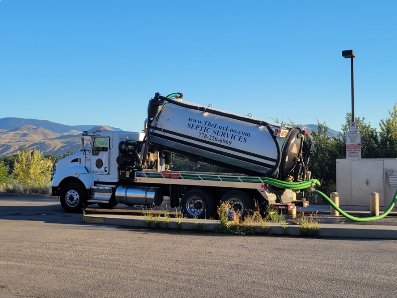 Lux Loo service truck pumping out a portable toilet unit on a construction site in the Thompson-Okanagan BC