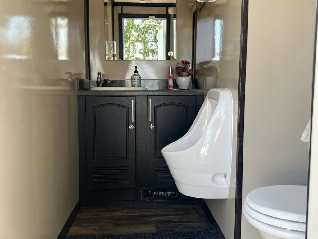 interior of a luxury washroom trailer showing individual stations with sinks and mirrors at a BC outdoor event