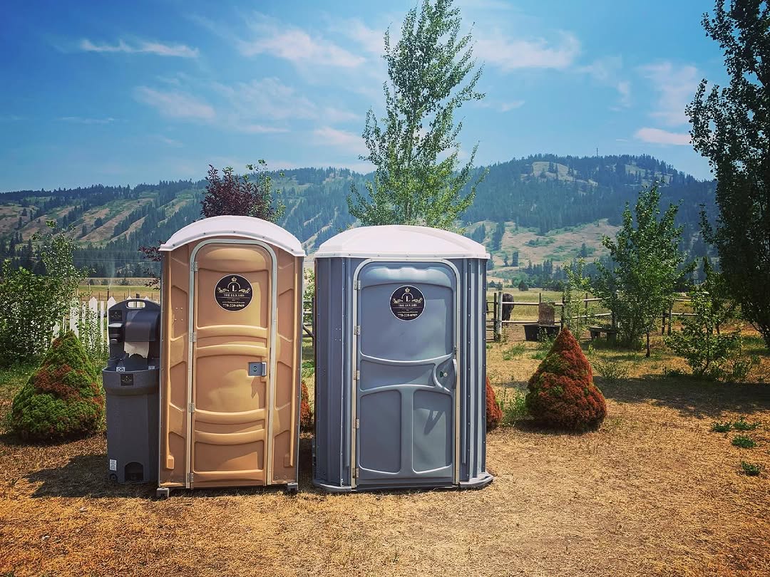 porta potty rental setup at a backyard party in Kamloops BC with trees and outdoor seating in background